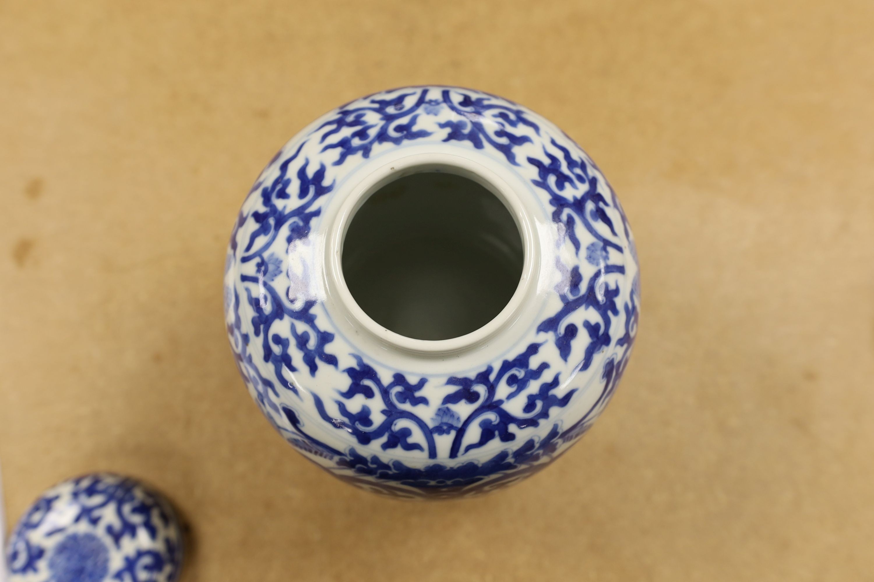 A pair of Chinese blue and white ginger jars and covers, 22cm, On stands